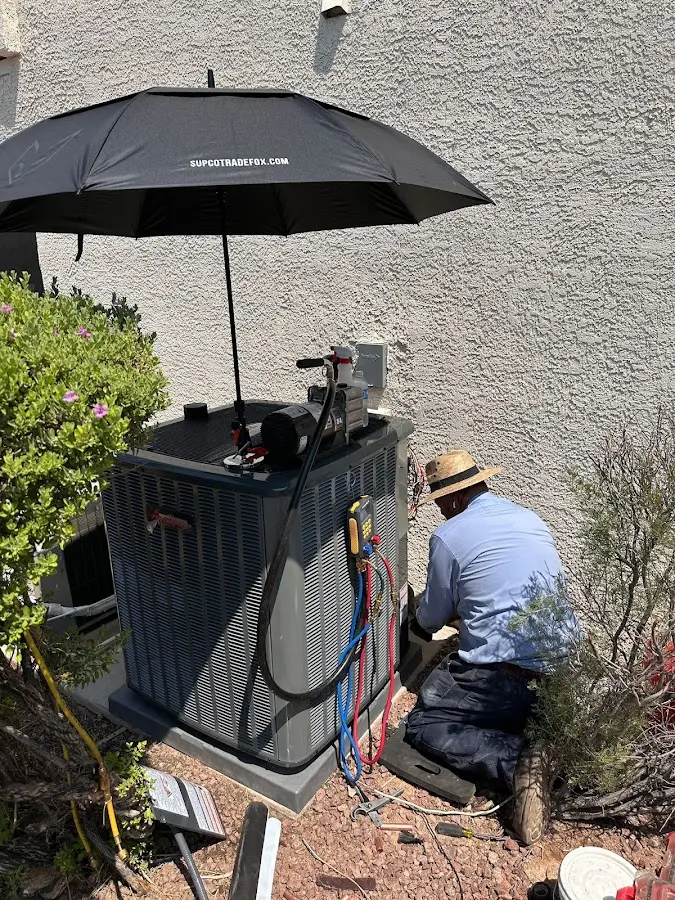 HVAC technician performing outdoor AC maintenance in Bremen