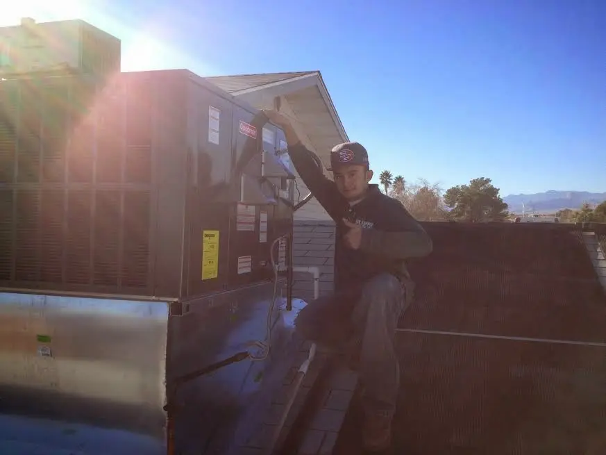 HVAC technician performing HVAC Inspection on a rooftop unit in Bremen